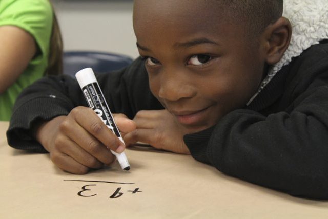 boy smiles as he benefits from an education project funded by Reisert Foundation