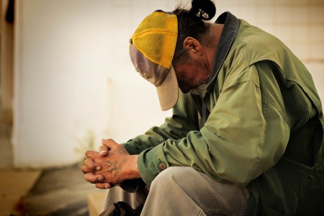 homeless man waiting to be served by a housing project funded by a grant from Reisert Foundation