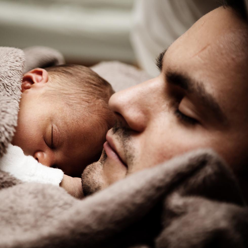 homeless father cuddles infant in a transitional shelter